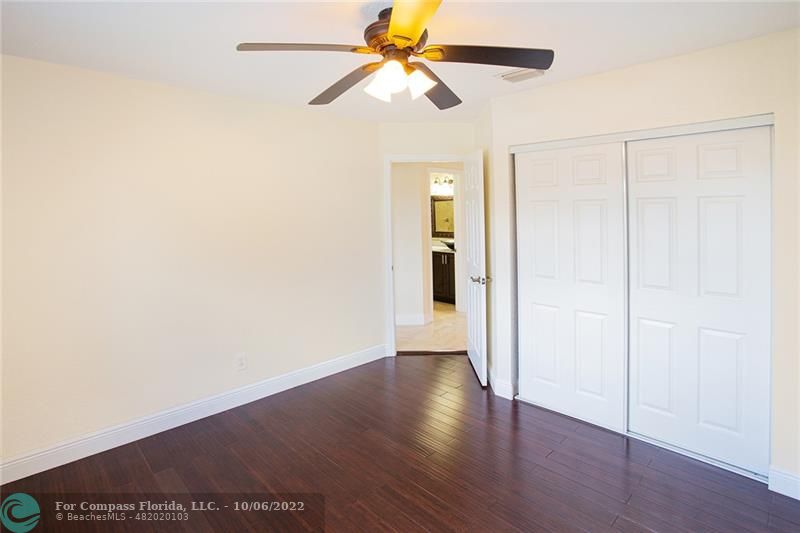 Winston Park Coconut Creek, FL 33073 - Photo 20 of 35 a view of a room with wooden floor and a ceiling fan