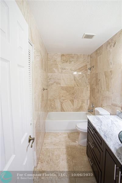 Winston Park Coconut Creek, FL 33073 - Photo 21 of 35 a bathroom with a granite countertop sink a toilet a mirror and bathtub