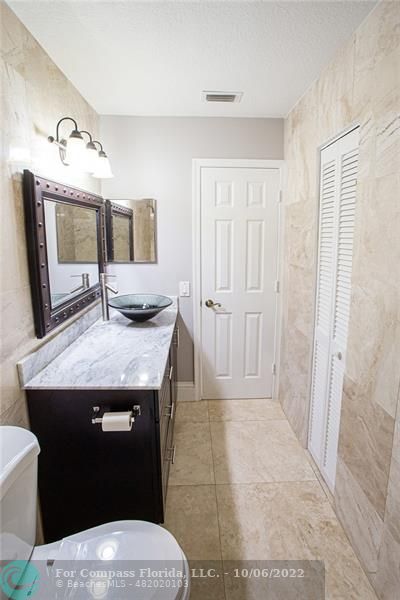 Winston Park Coconut Creek, FL 33073 - Photo 22 of 35 a kitchen with a sink a refrigerator and cabinets