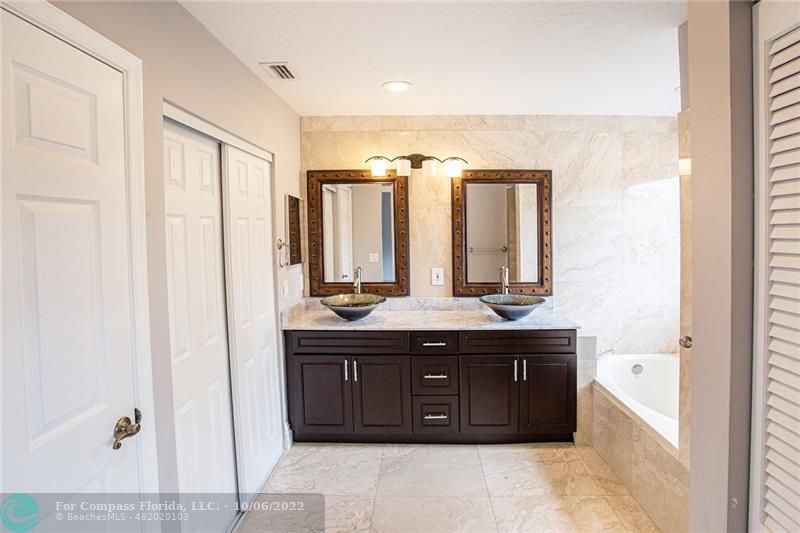 Winston Park Coconut Creek, FL 33073 - Photo 25 of 35 a bathroom with a granite countertop sink and a mirror