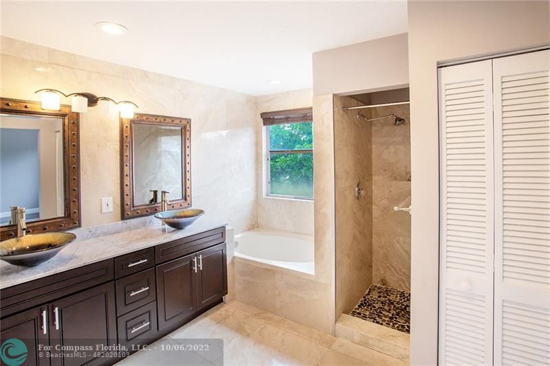 Winston Park Coconut Creek, FL 33073 - Photo 26 of 35 a spacious bathroom with a tub sink and mirror