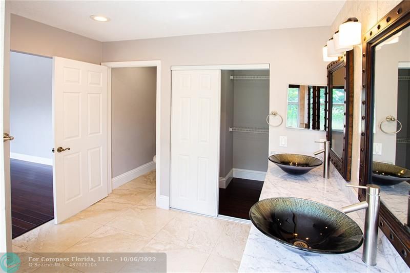 Winston Park Coconut Creek, FL 33073 - Photo 27 of 35 a bedroom with a bed and a large mirror