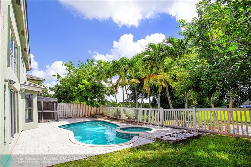Winston Park Coconut Creek, FL 33073 - Photo 29 of 35 a backyard of a house with table and chairs