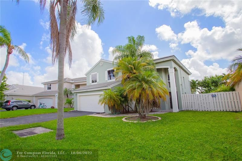 Winston Park Coconut Creek, FL 33073 - Photo 35 of 35 a front view of a house with garden