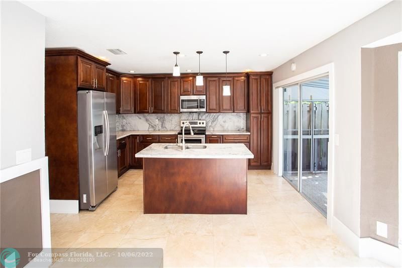 Winston Park Coconut Creek, FL 33073 - Photo 4 of 35 a view of kitchen with sink refrigerator and cabinets