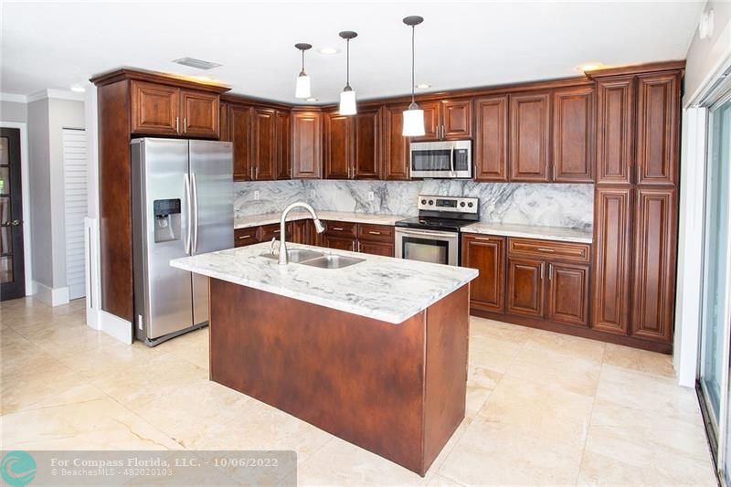 Winston Park Coconut Creek, FL 33073 - Photo 5 of 35 a kitchen with stainless steel appliances granite countertop a sink stove and refrigerator