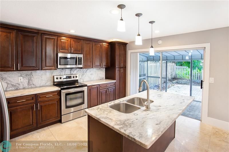 Winston Park Coconut Creek, FL 33073 - Photo 8 of 35 a kitchen with stainless steel appliances granite countertop a sink stove and refrigerator