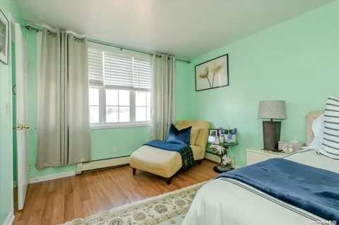 a bedroom with two beds and a chair