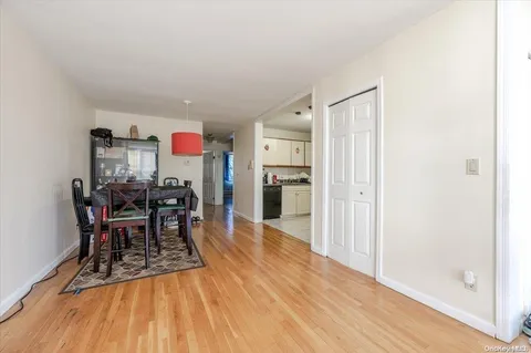 a dining room with furniture and wooden floor