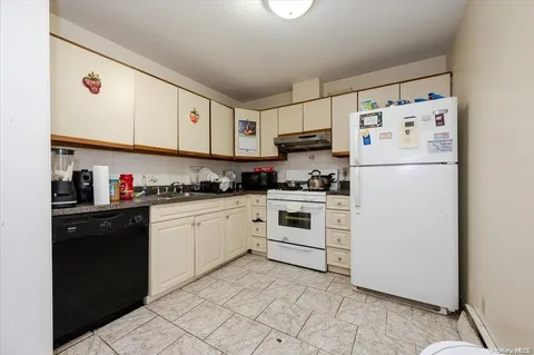 a white refrigerator freezer sitting inside of a kitchen