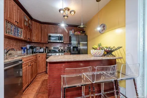 a kitchen with stainless steel appliances granite countertop a sink and cabinets