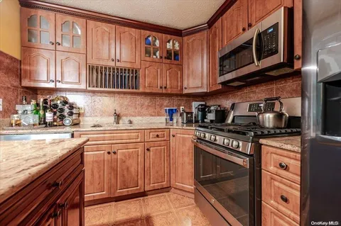 a kitchen with stainless steel appliances granite countertop a stove microwave and cabinets