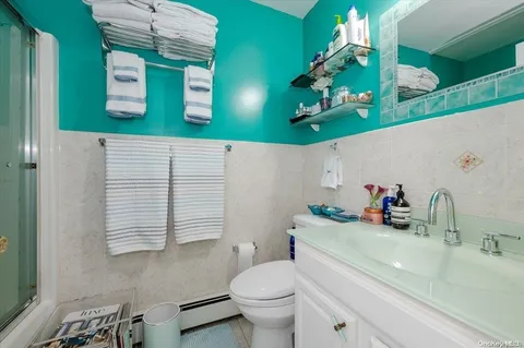 a bathroom with a sink a toilet and mirror