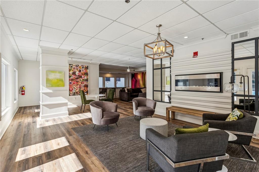 275 13th Street Northeast, Unit 707 Atlanta, GA 30309 - Photo 12 of 17 a living room with couches a dining table and chairs with outer view