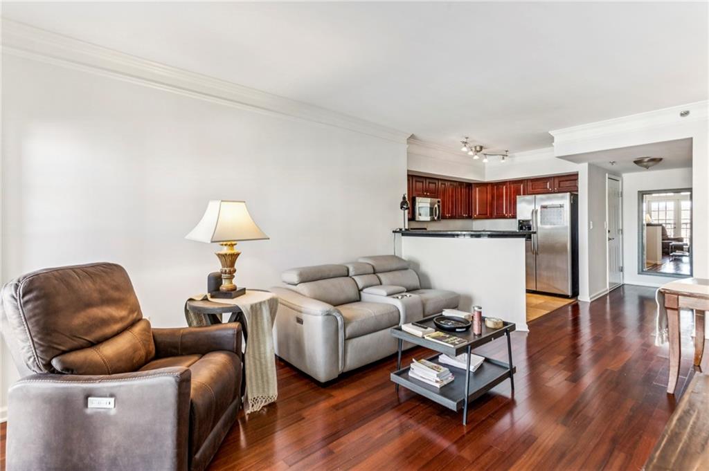 275 13th Street Northeast, Unit 707 Atlanta, GA 30309 - Photo 2 of 17 a living room with furniture and wooden floor