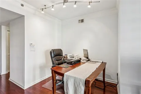 a view of a workspace with furniture and wooden floor
