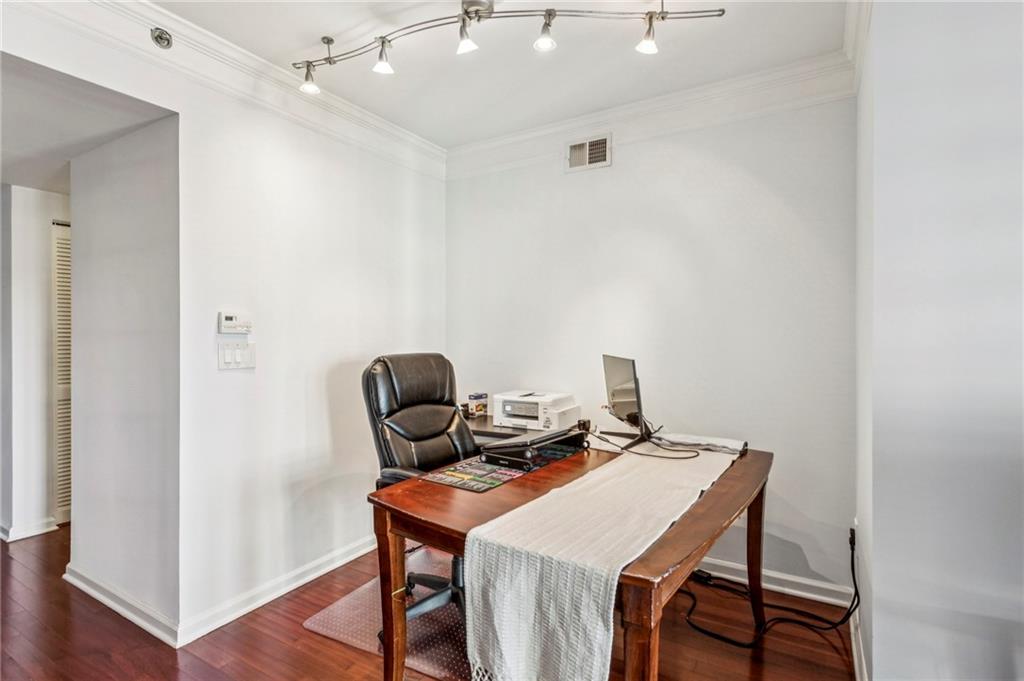 275 13th Street Northeast, Unit 707 Atlanta, GA 30309 - Photo 4 of 17 a view of a workspace with furniture and wooden floor