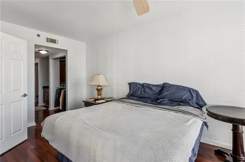 a bed sitting in a bedroom and a mirror