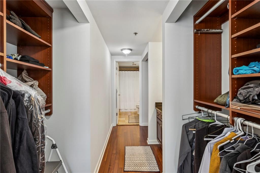 275 13th Street Northeast, Unit 707 Atlanta, GA 30309 - Photo 7 of 17 a view of walk in closet with clothes and shoes