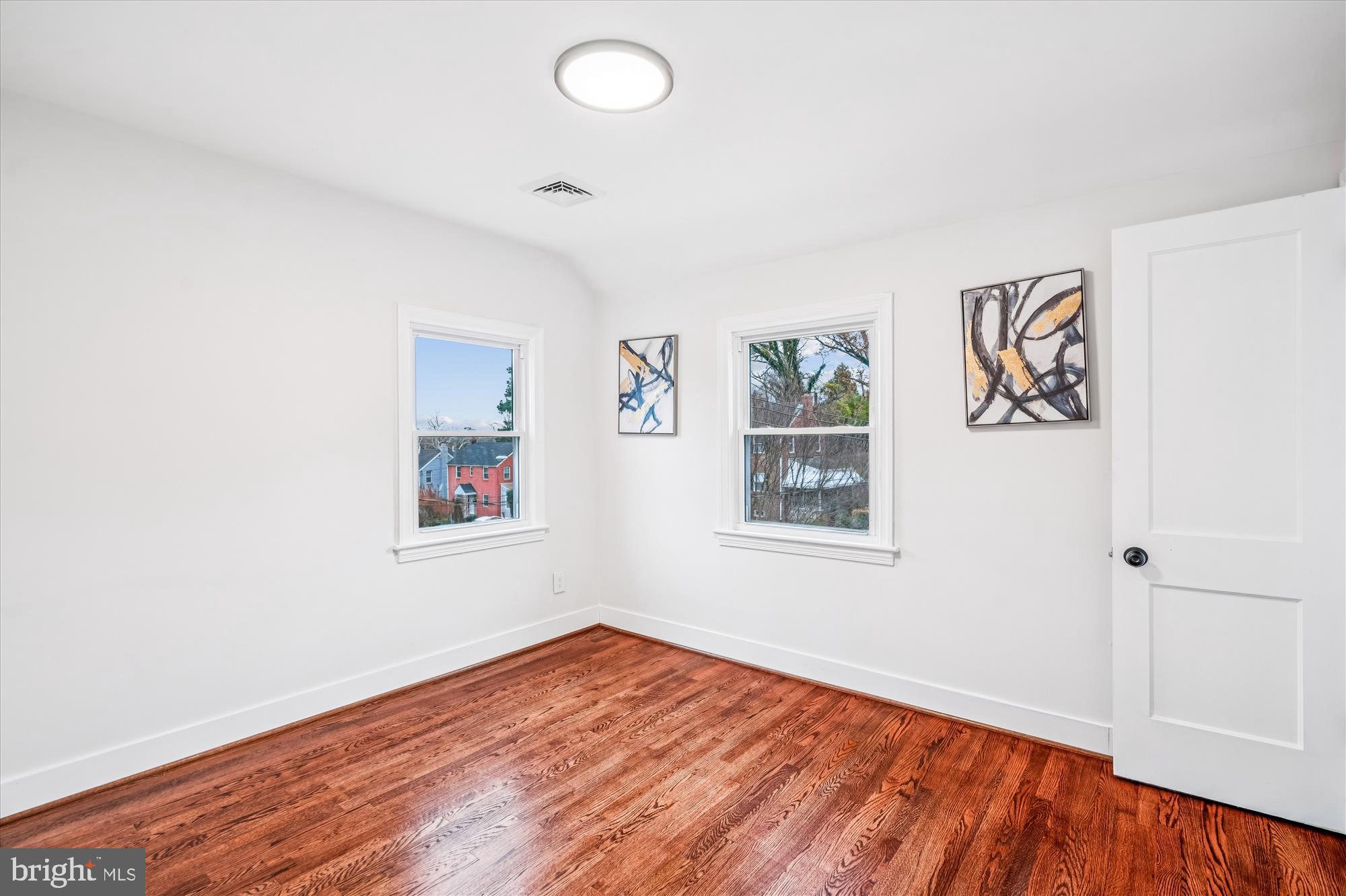 5408 14th Place Hyattsville, MD 20782 - Photo 13 of 49 an empty room with a window and wooden floor