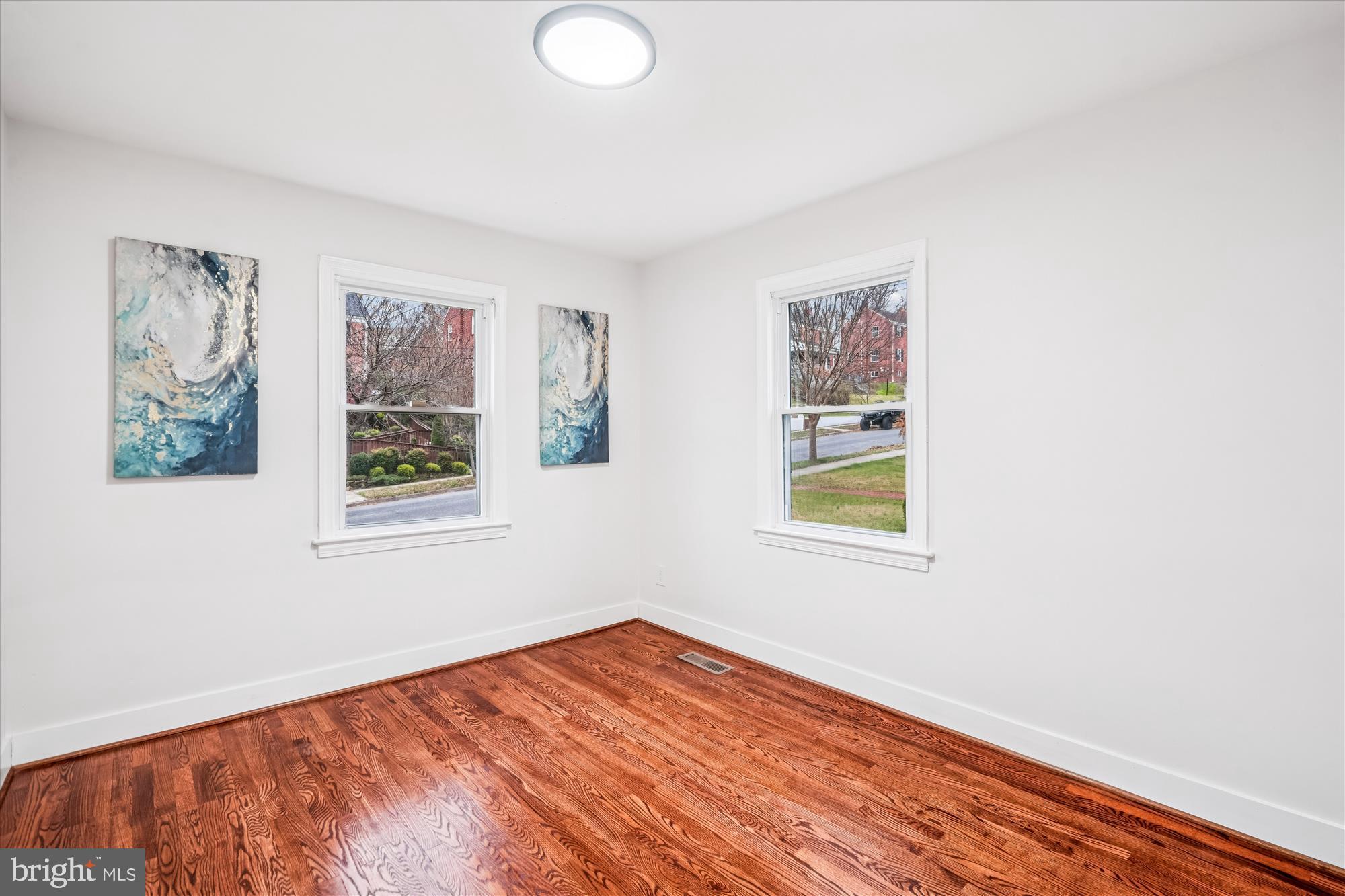 5408 14th Place Hyattsville, MD 20782 - Photo 16 of 49 a view of an empty room with window and wooden floor
