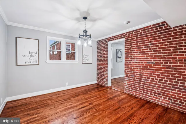 a view of a livingroom with wooden floor and window
