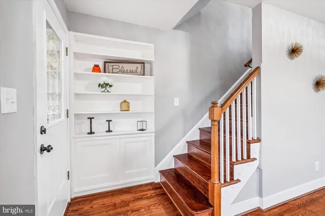 a view of staircase with white walls and a window