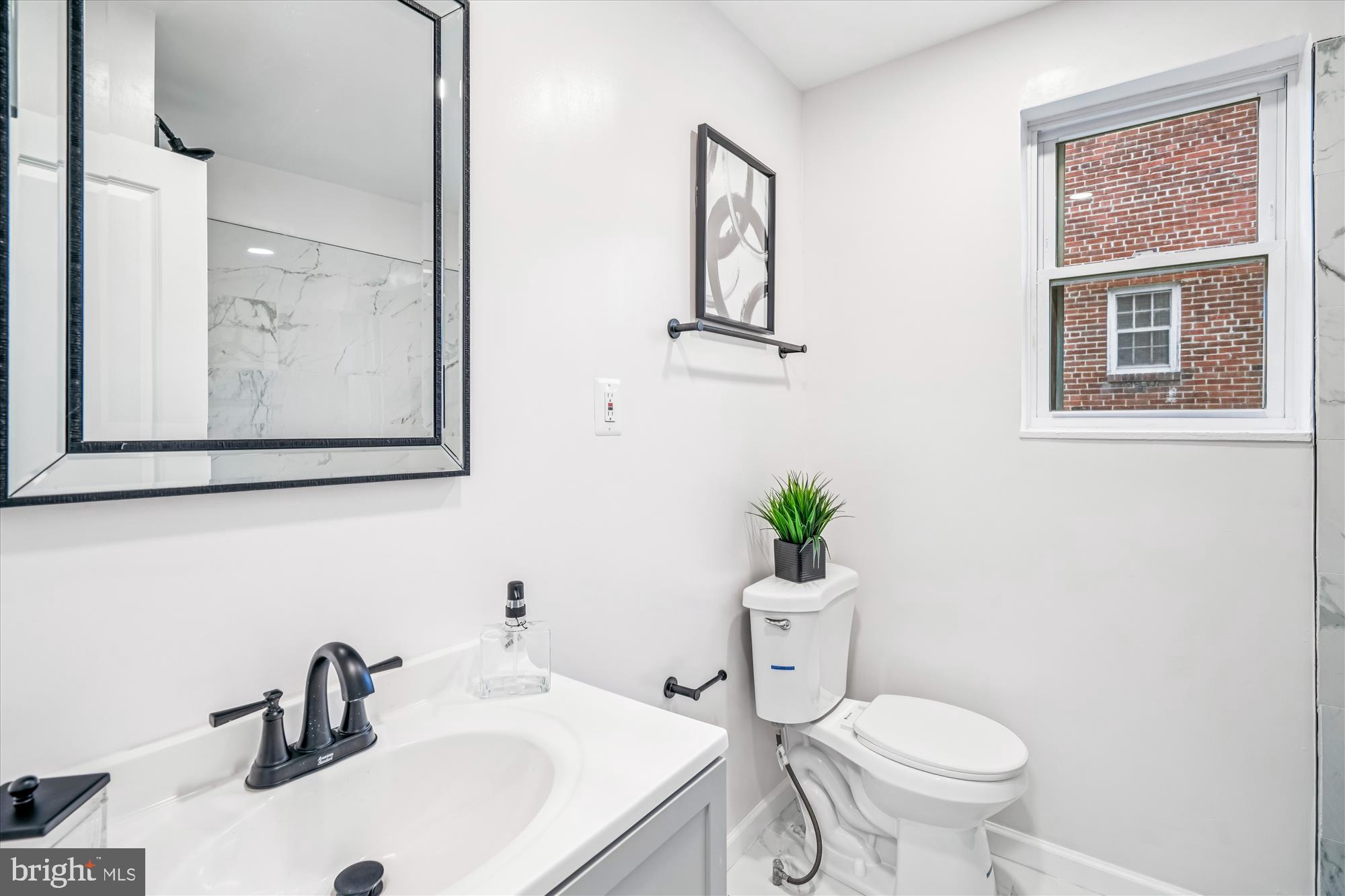 5408 14th Place Hyattsville, MD 20782 - Photo 7 of 49 a bathroom with a sink mirror and toilet