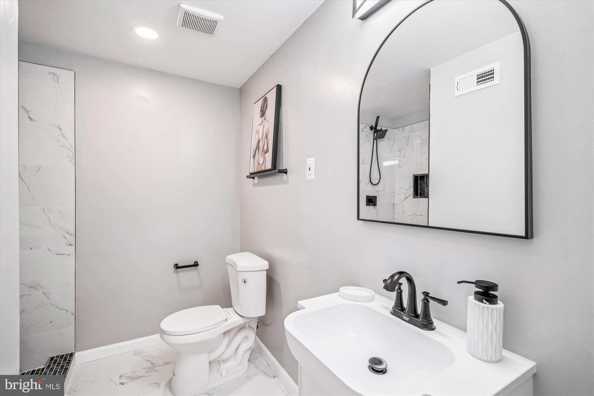 5408 14th Place Hyattsville, MD 20782 - Photo 8 of 49 a bathroom with a toilet sink and mirror