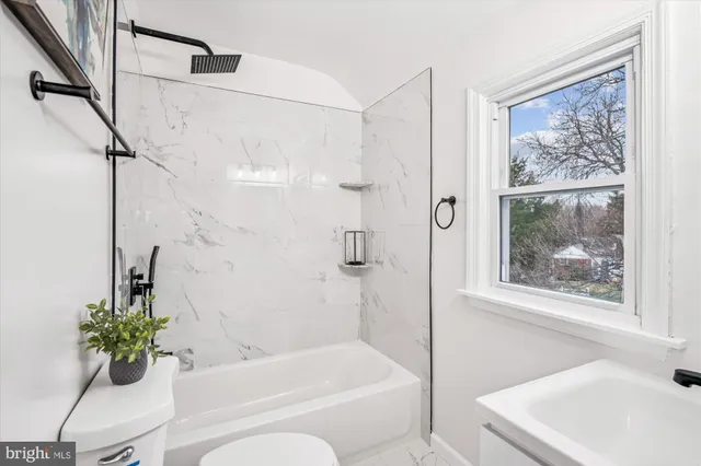 a bathroom with a tub shower and sink