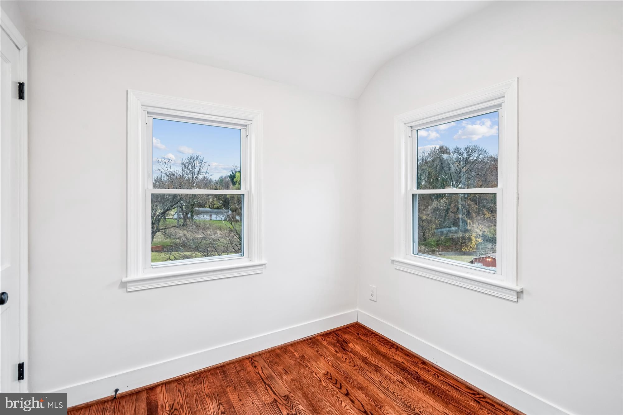 5408 14th Place Hyattsville, MD 20782 - Photo 10 of 49 a view of an empty room with a window and wooden floor