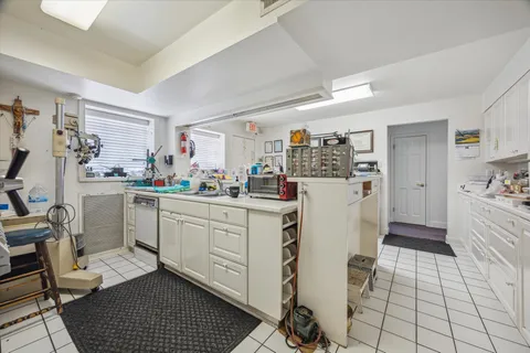 a kitchen with a sink cabinets and refrigerator