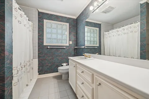a bathroom with a sink a toilet and a shower