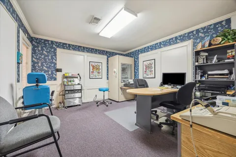 a view of a livingroom with workspace and a couch