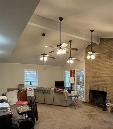 a living room with furniture a fireplace and a chandelier