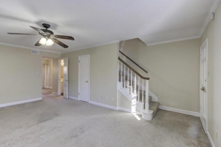 5718 Quince Road, Unit 10 Memphis, TN 38119 - Photo 4 of 28 Unfurnished living room featuring stairway, ornamental molding, light carpet, and ceiling fan