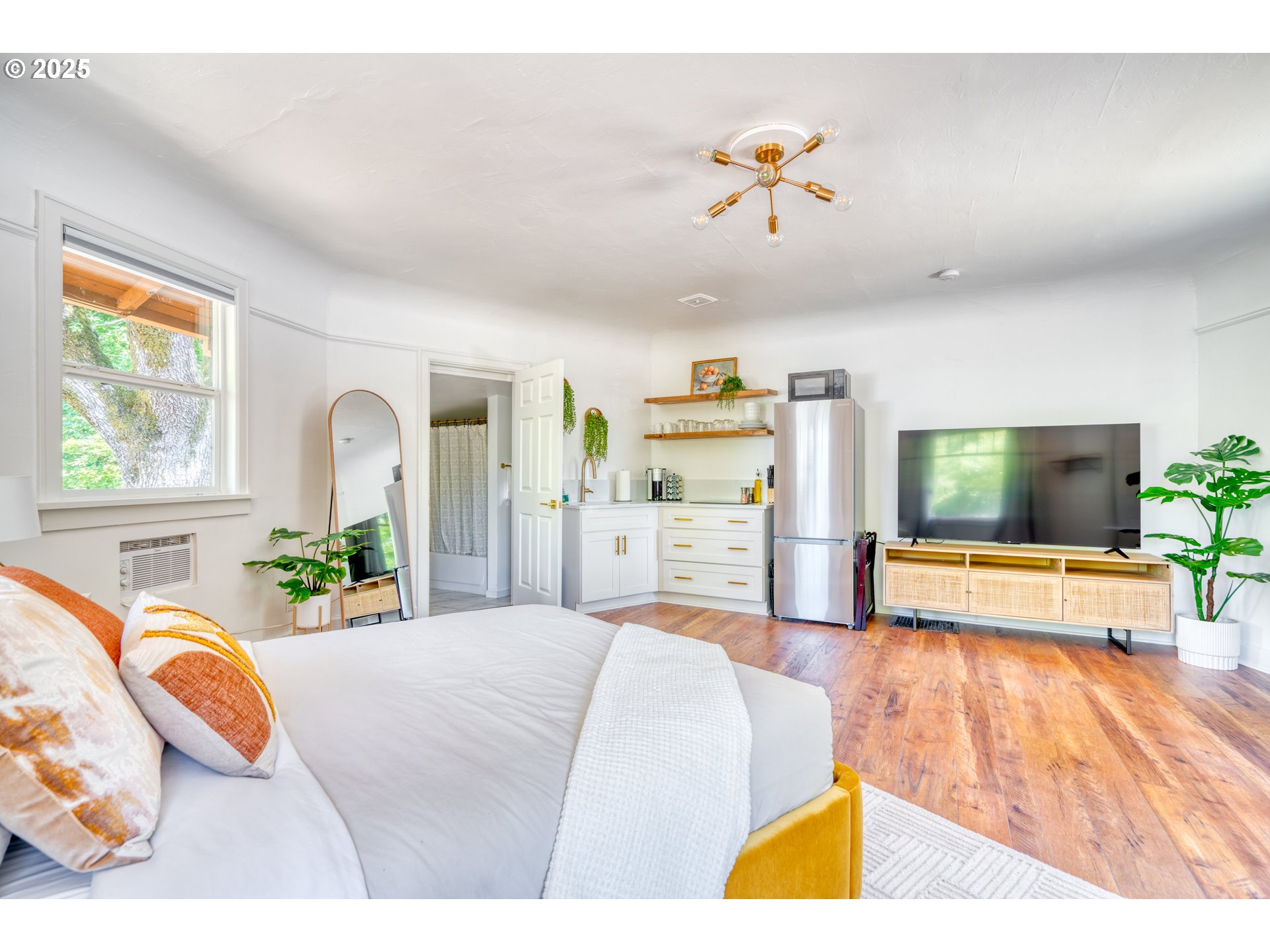 9647 Southwest Capitol Highway Portland, OR 97219 - Photo 15 of 33 a bedroom with a bed and a chandelier