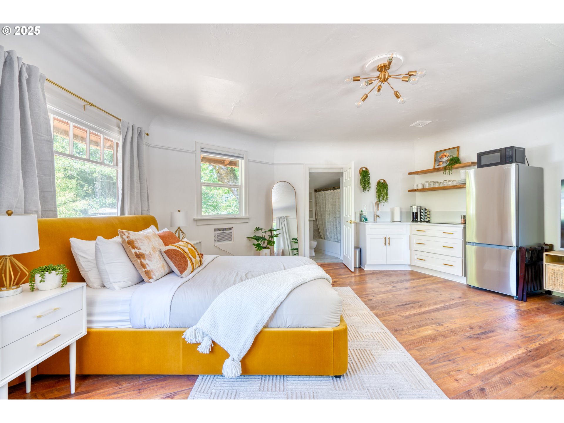 9647 Southwest Capitol Highway Portland, OR 97219 - Photo 16 of 33 a bed room with a bed and a couch