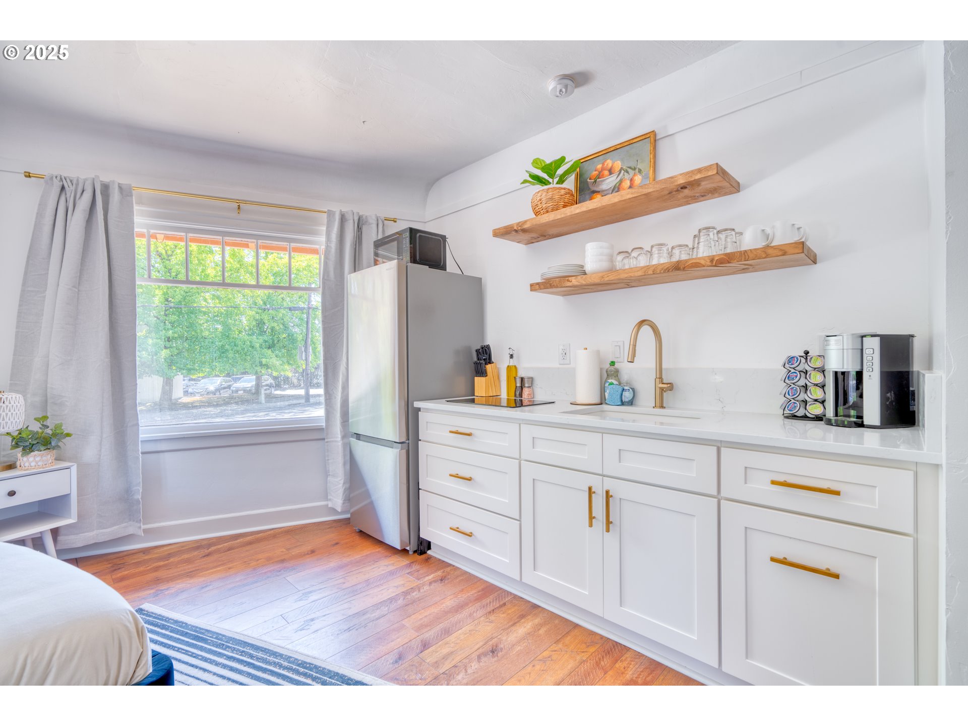 9647 Southwest Capitol Highway Portland, OR 97219 - Photo 18 of 33 a kitchen with stainless steel appliances cabinets and a large window
