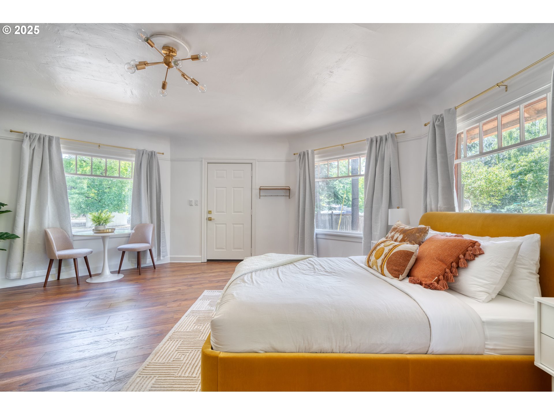 9647 Southwest Capitol Highway Portland, OR 97219 - Photo 25 of 33 a bedroom with a large bed and a table