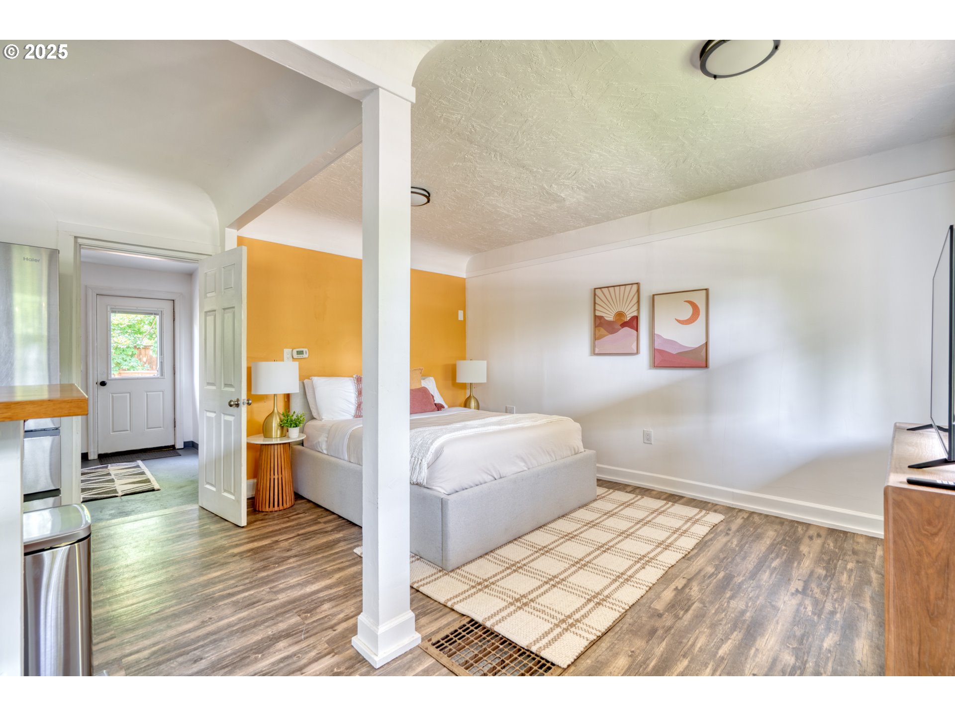 9647 Southwest Capitol Highway Portland, OR 97219 - Photo 26 of 33 a bedroom with a bed and wooden floor
