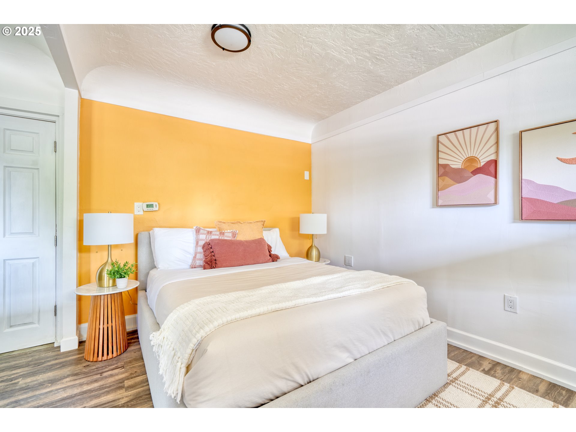 9647 Southwest Capitol Highway Portland, OR 97219 - Photo 27 of 33 a bedroom with a bed and a painting on the wall