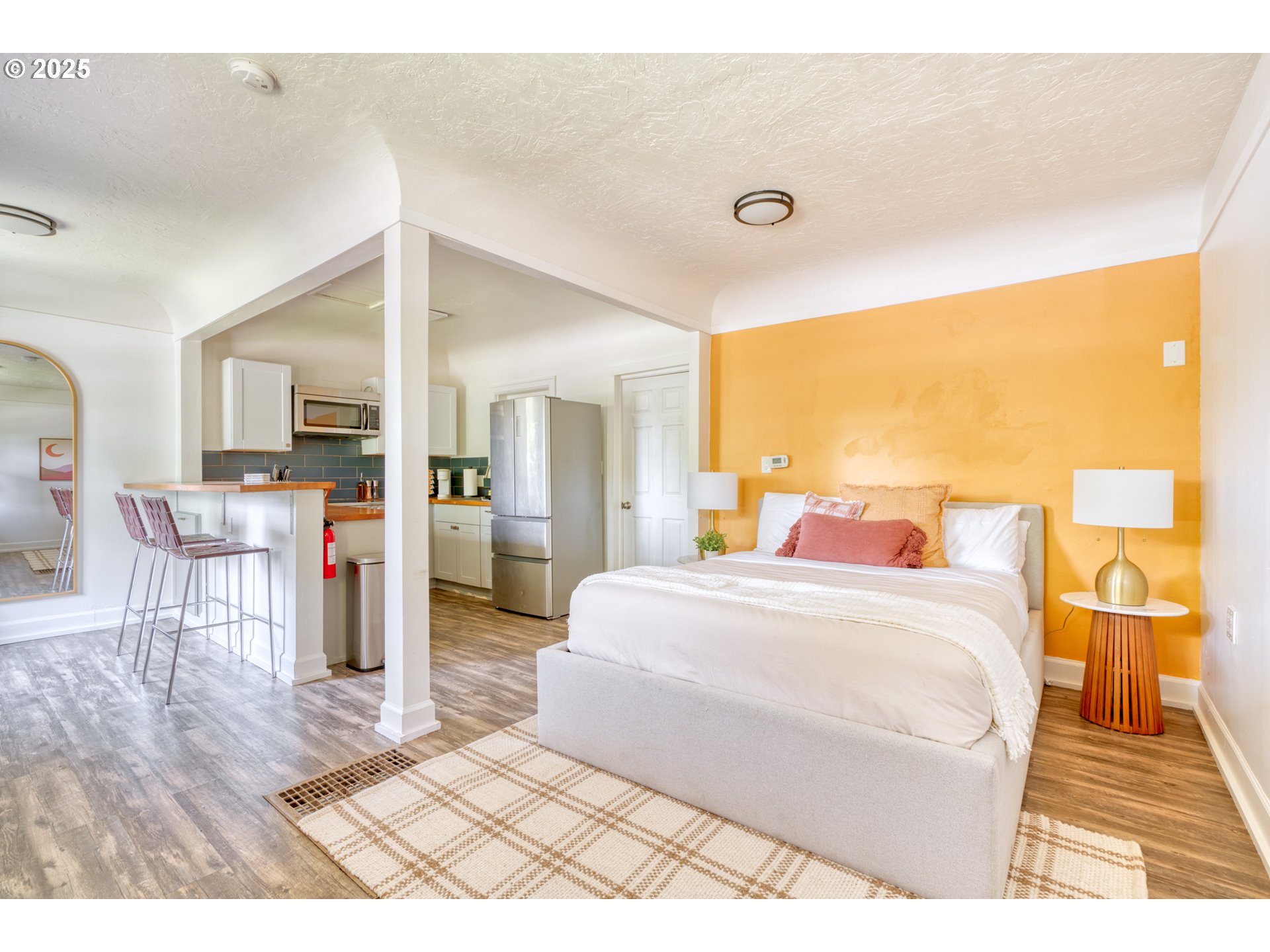 9647 Southwest Capitol Highway Portland, OR 97219 - Photo 28 of 33 a bedroom with a bed and wooden floor