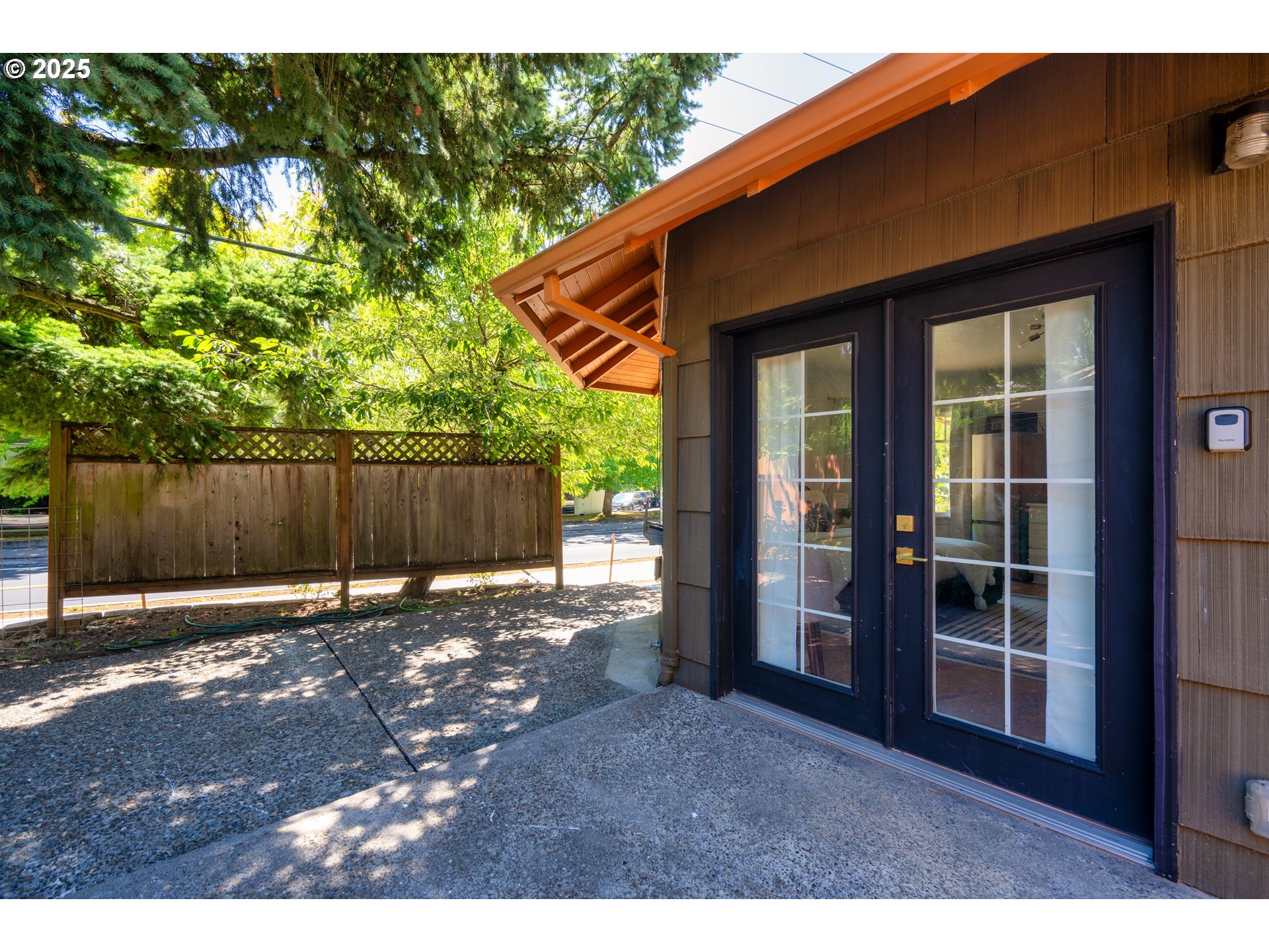 9647 Southwest Capitol Highway Portland, OR 97219 - Photo 4 of 33 a backyard of a house with table and chairs