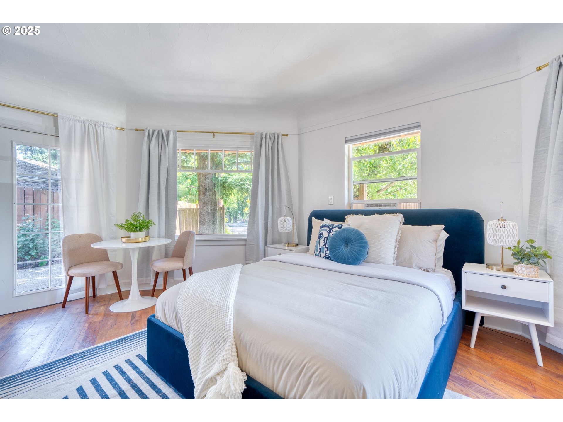 9647 Southwest Capitol Highway Portland, OR 97219 - Photo 9 of 33 a bedroom with a bed and a table