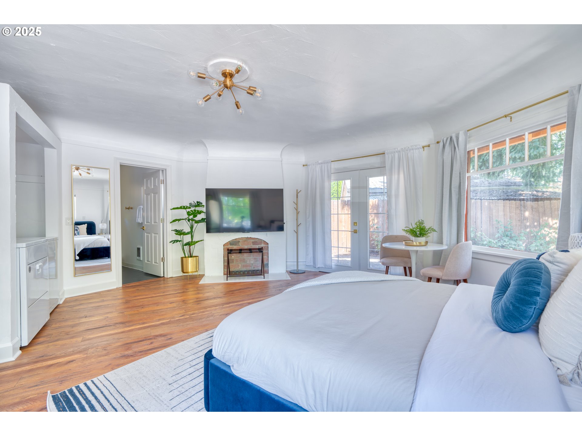 9647 Southwest Capitol Highway Portland, OR 97219 - Photo 10 of 33 a living room with furniture a fireplace and a floor to ceiling window