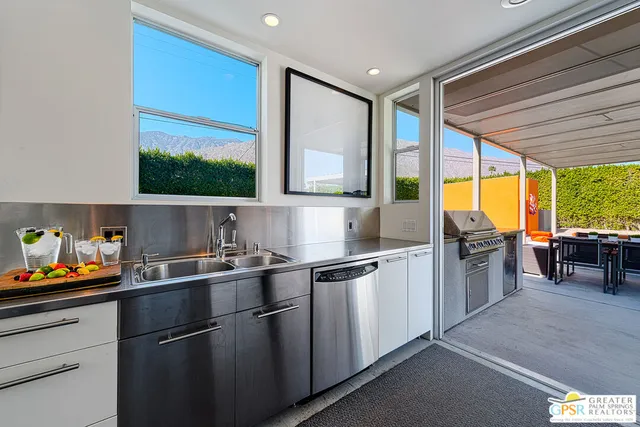 a outdoor dining space with furniture and outdoor kitchen view
