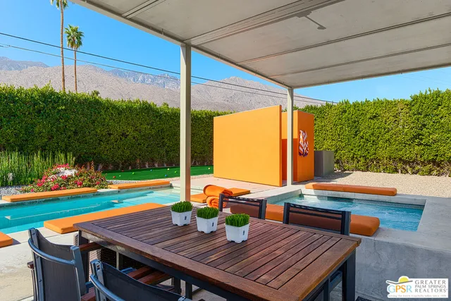 a view of swimming pool with lounge chair and dinning table