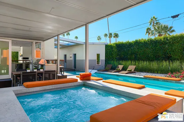 a view of swimming pool with a lounge chairs