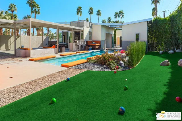 a view of a house with backyard porch and sitting area